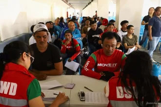 DSWD photo: Shows riders receiving cash aid