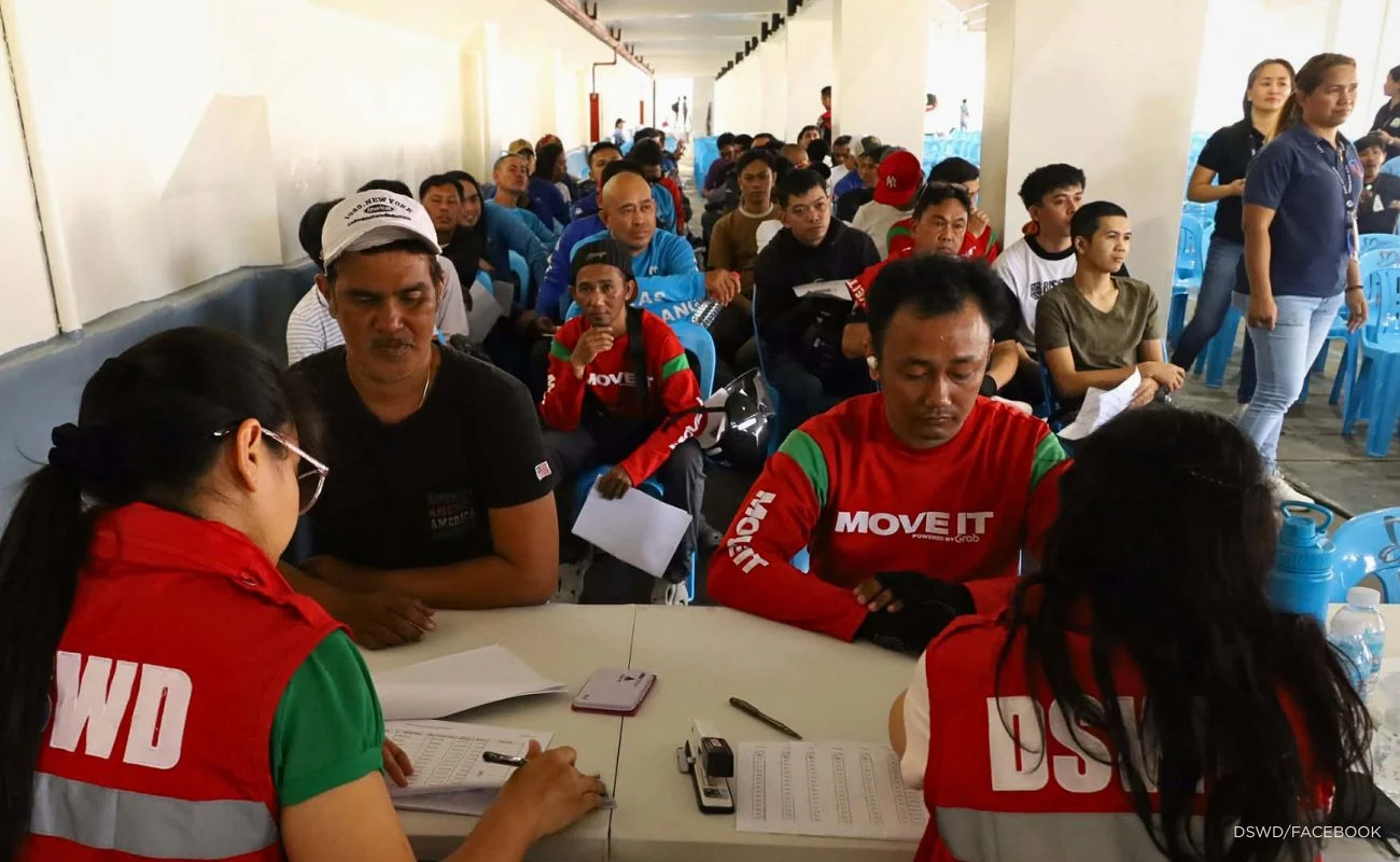 DSWD photo: Shows riders receiving cash aid