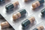 A stock image of Doxycycline capsules in silver blister packaging.
