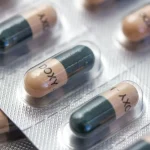 A stock image of Doxycycline capsules in silver blister packaging.