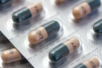 A stock image of Doxycycline capsules in silver blister packaging.