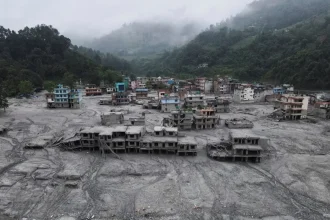A drone view shows houses covered in mud after the flash floods and mudslide, at Devighat, Nuwakot district, Nepal, August 29, 2026. REUTERS/Francis Mascarenhas