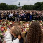 Mourners gather to pay their respects outside the Royal Palace, following the death of Norway's King Harald, in Oslo, Norway, August 28, 2026. (NTB/Cornelius Poppe)