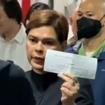 Vice President Sara Duterte showing a court order to reporters on Sept. 5 confirming that she had posted bail at the Quezon City Regional Trial Court for an arrest warrant over her grave threats case.